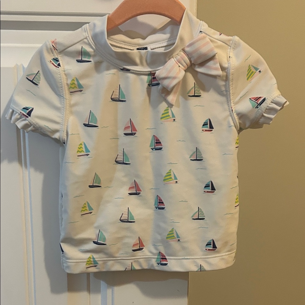Janie and Jack, short sleeve rashguard with multi-colored sailboats & pink bow.